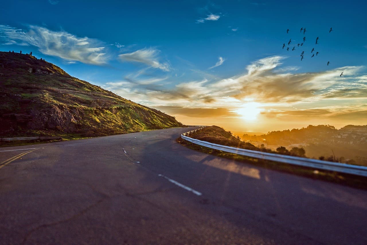 Winding road at sunrise representing a clear path forward